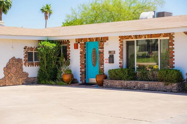 Front entrance of Best Elderly Care with a blue door and landscaping