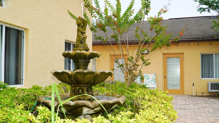 A decorative fountain surrounded by greenery at The Club at St. Cloud.