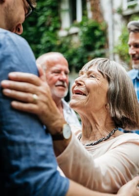 Residents engaging warmly during an outdoor event