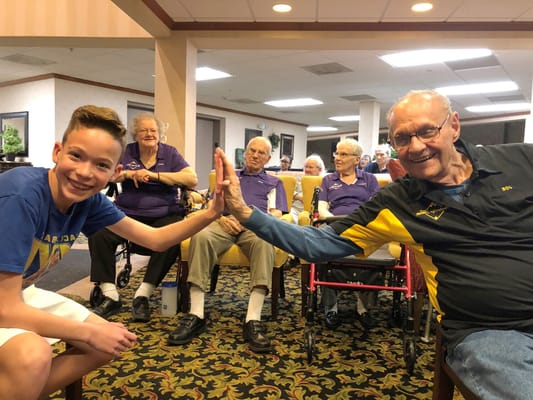 Residents and a young visitor interacting during a social event