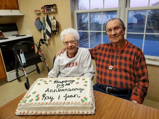 Residents celebrating their 73rd anniversary with a cake