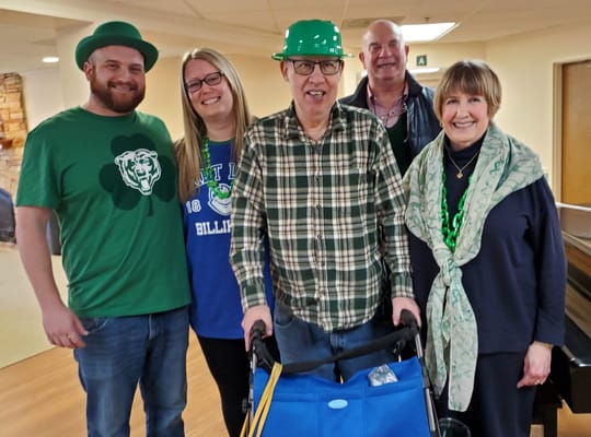 Residents and staff celebrating together in green attire