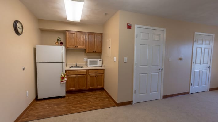 A kitchenette area in a private resident room