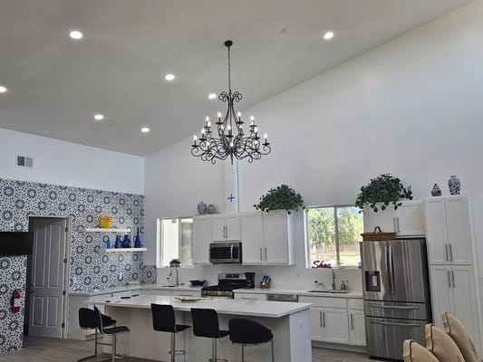 Modern kitchen interior with high ceilings and elegant lighting