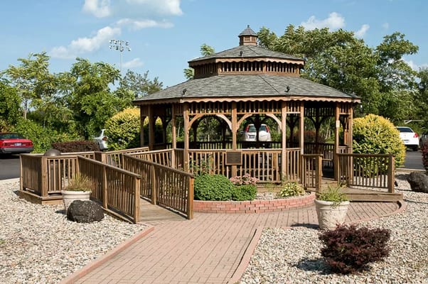 Outdoor gazebo surrounded by landscaped gardens