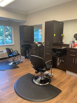 Hair salon area with styling chairs and mirrors