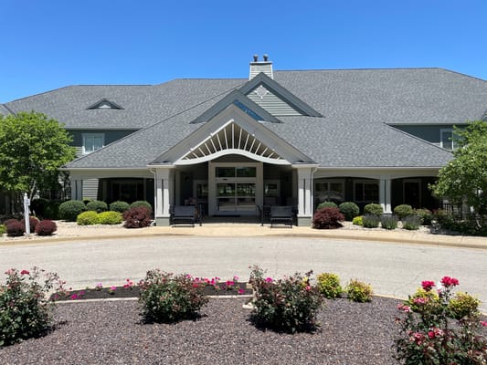 Exterior view of a senior living facility with landscaped gardens