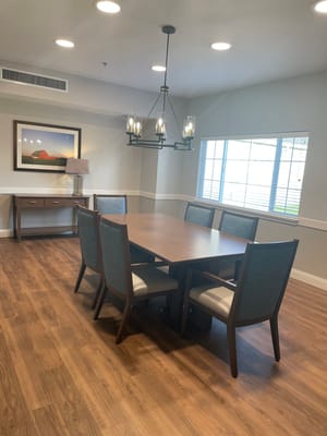 Bright common area with dining table and chairs