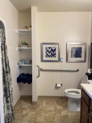 Well-decorated bathroom with towels and artwork