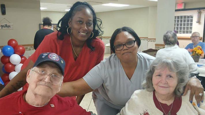 Residents and staff posing in a common area