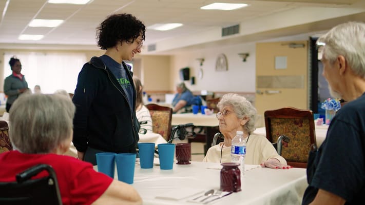 Staff engaging with residents during an activity in a common area