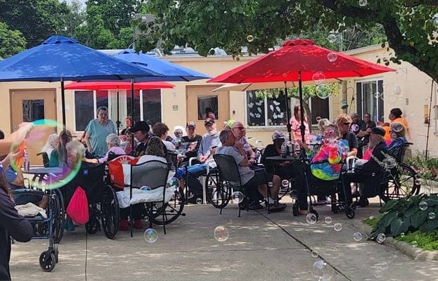 Residents enjoying an outdoor activity with bubbles