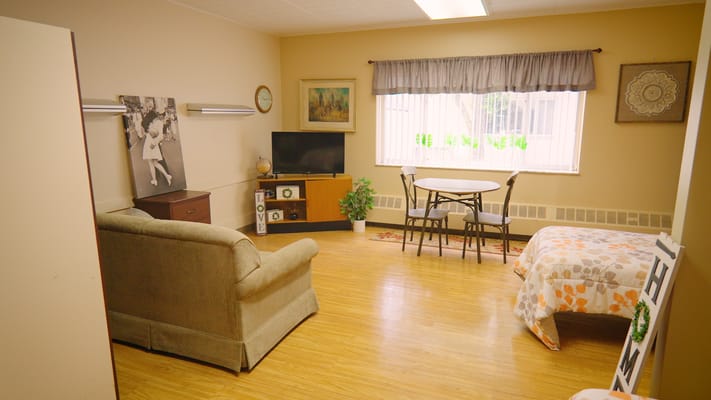 Cozy resident room with seating and dining area