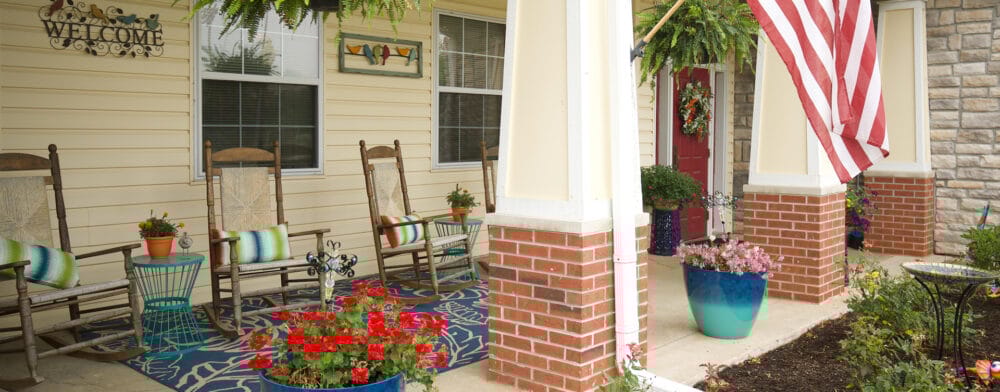 Welcoming porch area with rocking chairs and flowers