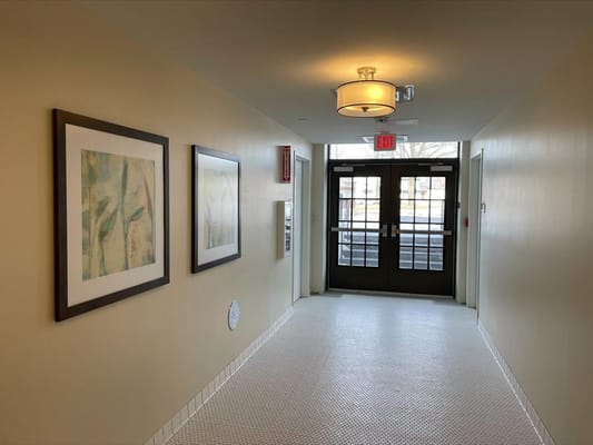 Bright hallway with artwork and double doors