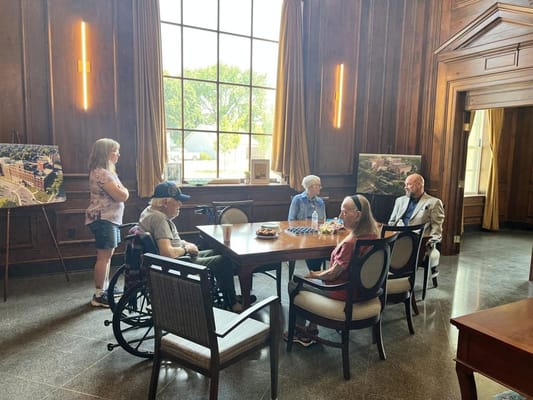Residents chatting around a table in a cozy common area