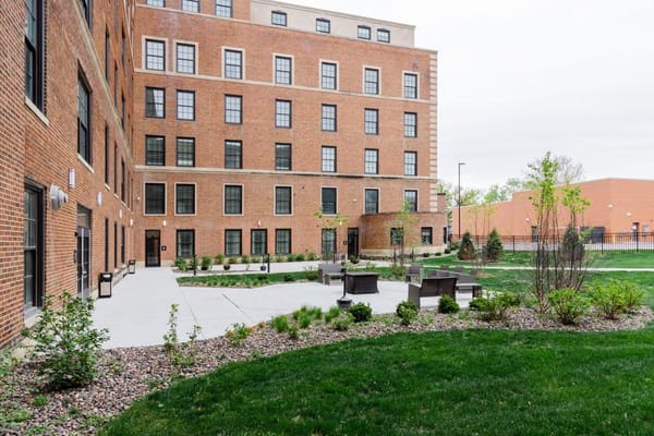 Exterior view of Bardwell Residences with outdoor seating area