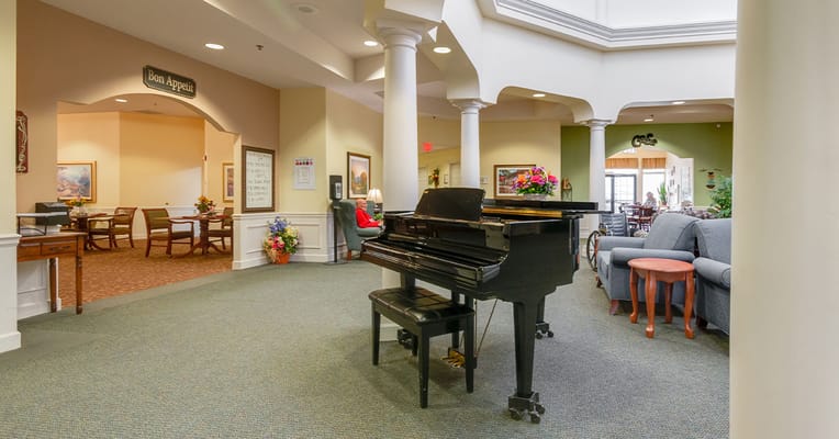 An interior view of a welcoming common area with a piano