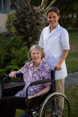 Staff member assisting a resident in a garden area