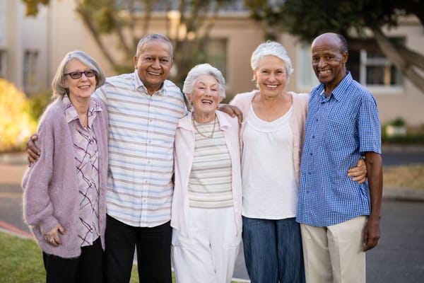 Residents posing together in a sunny outdoor area