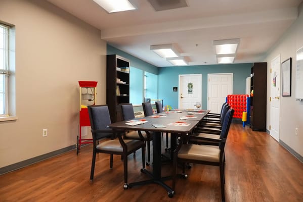 Bright activity room with tables and chairs