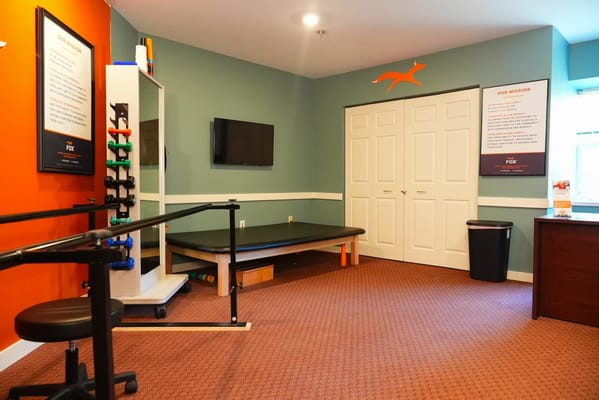 Therapy room with exercise equipment and therapy table