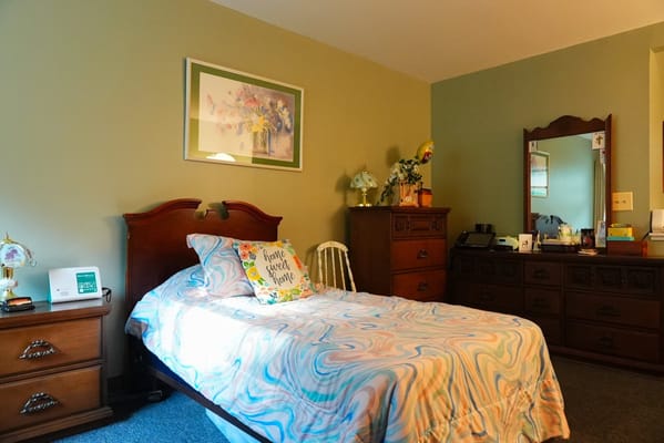 Cozy resident room with a colorful bedspread and decor