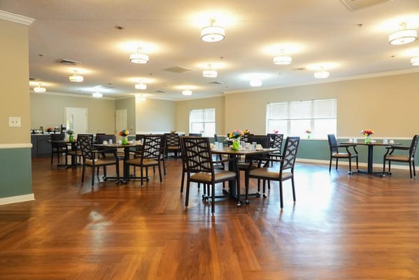 Bright dining room with tables and flowers