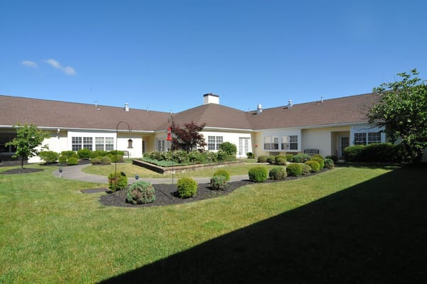 Exterior view of a landscaped assisted living facility