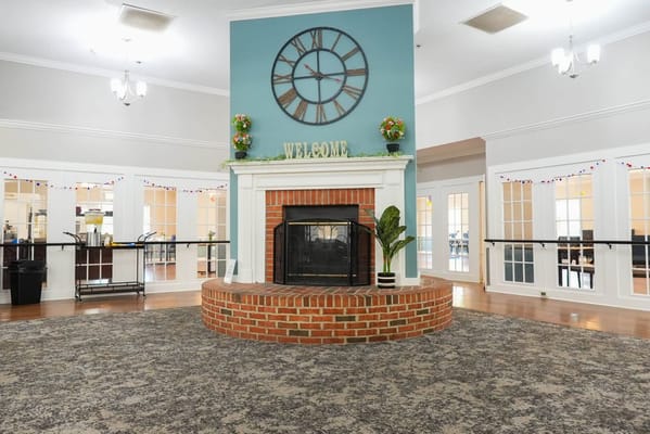 Interior view of a welcoming common area with fireplace
