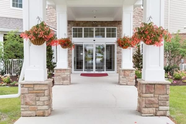 Main entrance featuring decorative hanging plants and stone columns