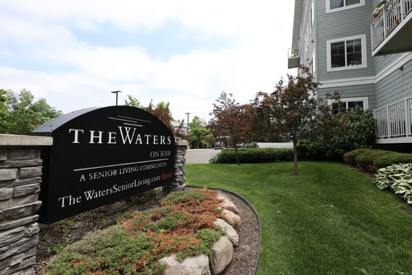 Exterior view of The Waters on 50th entrance sign and landscaping