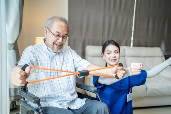 Resident participating in physical therapy with staff
