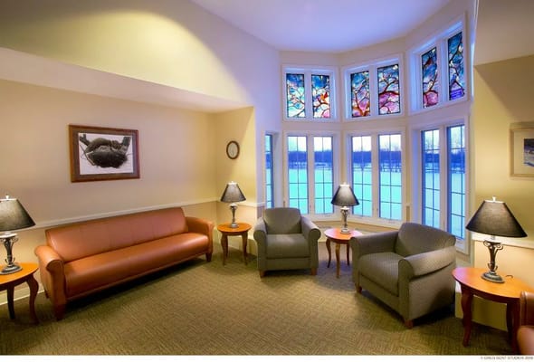 Warm living room with stained glass windows and comfortable seating