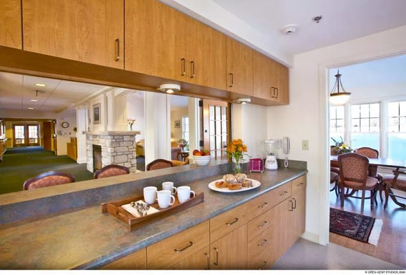Spacious kitchen area with a tray of pastries and beverages.