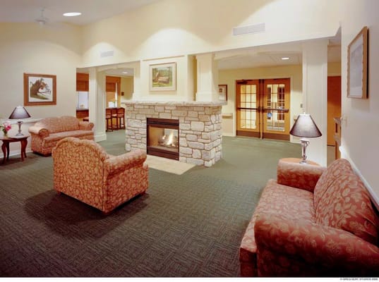 Warm and inviting lobby featuring a stone fireplace and comfortable seating
