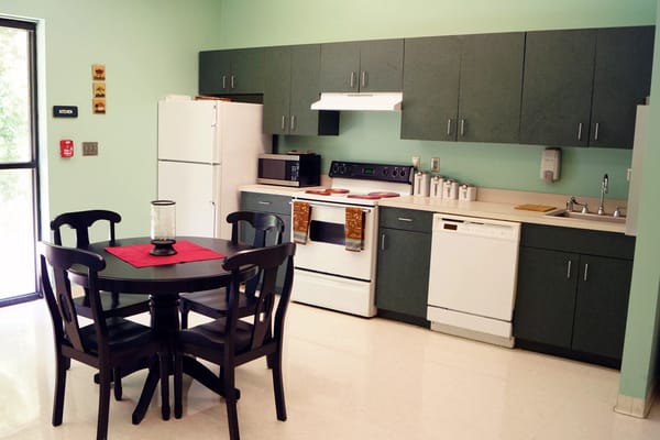 Interior kitchen space with dining table and appliances