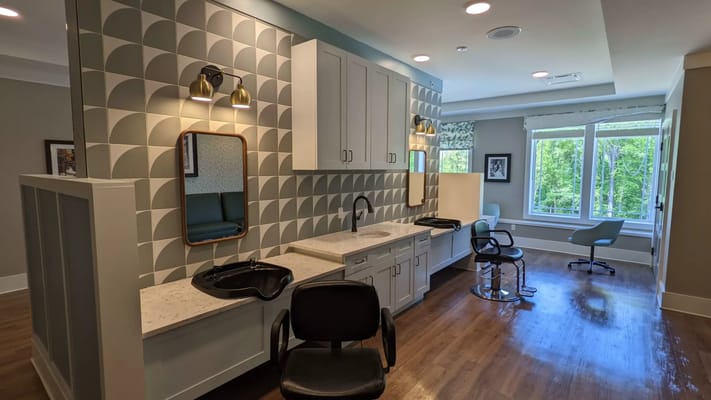 Hair salon area with chairs and mirrors