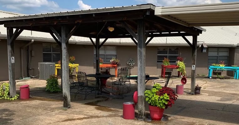 Outdoor patio area with colorful planters and seating