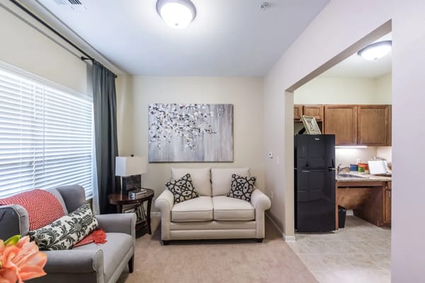 Cozy living room with a couch and kitchenette