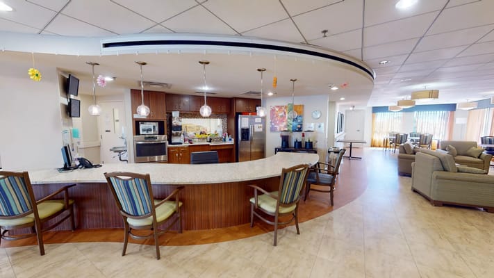 Interior view of a community lounge and kitchen area