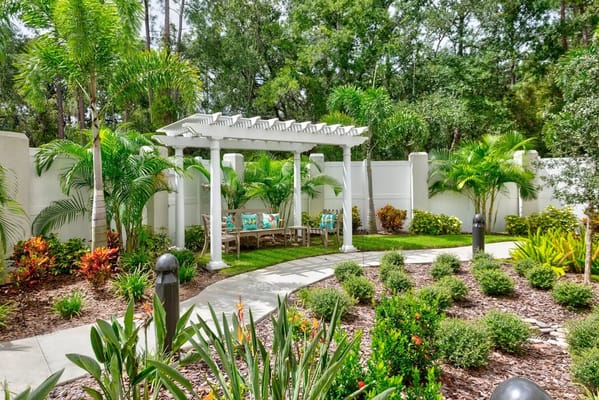 A serene outdoor garden area with seating and greenery