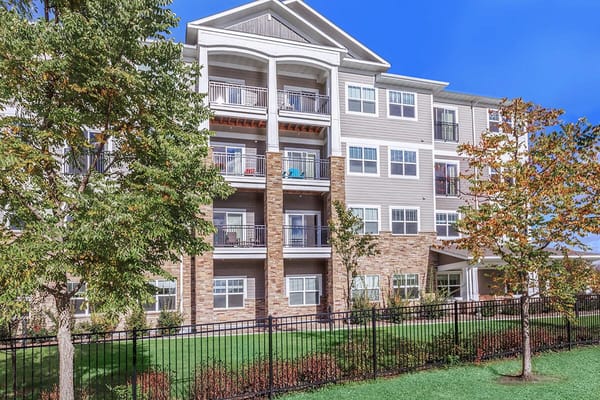 Exterior view of a senior living facility with landscaping