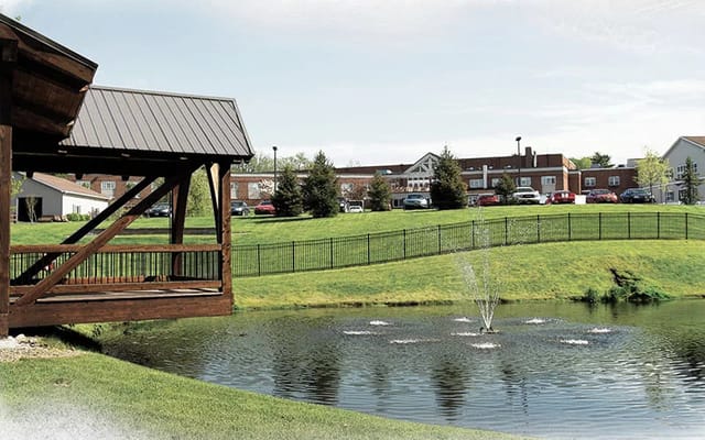 View of a pond with a fountain and a gazebo at Memory Garden.