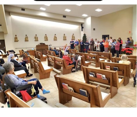 Residents and staff participating in a group activity in the common area