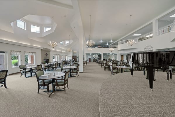 Spacious dining room with tables and chandeliers