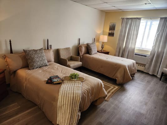 Two cozy resident bedrooms with natural light