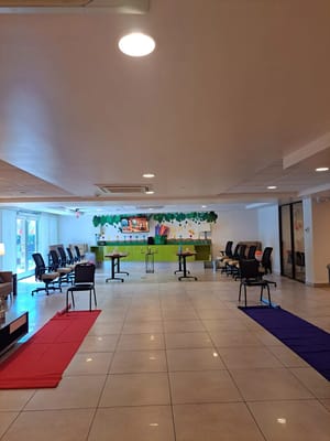 Bright common area with chairs and tables arranged