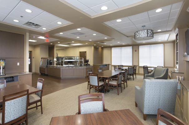 Bright dining area with tables and a buffet station