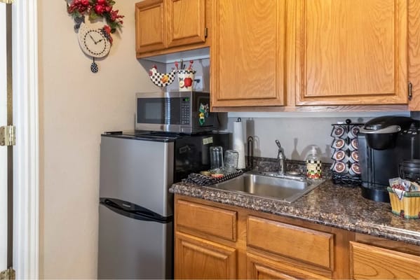 A kitchen area with appliances and decor